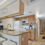Cute step-saver kitchen with granite counters and breakfast bar....