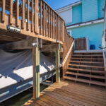 Stairs from patio to water and boat lift under the patio.
