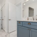 Primary Bathroom w/ 2 vanities, 2 toilets, shower, tub, walk in closet.