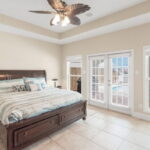 Owner's primary bedroom with views of pool and water canal - WOW!!