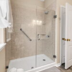 Hall guest bath with a gorgeous walk-in shower. Linen closet behind the door.