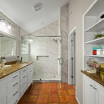 Primary bath features double sinks, walk-in shower & closet.