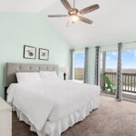 Spacious primary bedroom with Water and Beach views!