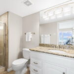 En Suite Bath Off 1st Bedroom With Remodeled & Enlarged Tile Shower in 2019. Replaced mirror, lighting and Faucets in 2022 -2023.