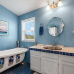 Primary bathroom with whimsical claw-foot tub.