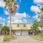 Two car garage with plenty of parking space in the driveway.