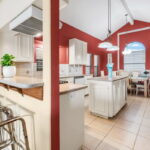 Kitchen entrance from the living area with Breakfast Bar, Island and Formal Dining Area.