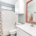 Hall bath with linen/towel closet for storage.