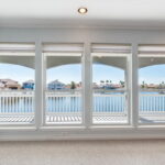 Enjoy the amazing canal views & covered patio from the primary suite.