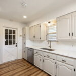 Lots of counter space. Leave the kitchen and walk into the garage.