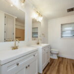 Guest bathroom located before additional guest bedrooms.