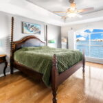 Spacious and bright primary bedroom with waterfront views.