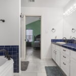 Primary bathroom is equipped with garden tub and walk-in shower.