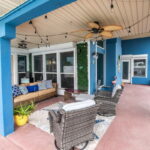 Covered back patio with dining room door on the left and primary suite door on the right.