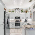 Kitchen with granite countertops and under cabinet lighting.