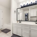 Primary Vanity with Dual Sinks and Garden Tub.