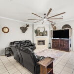 Living area with woodburning fireplace.