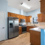 Kitchen with fridge that conveys with property.