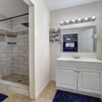 Primary bath with tiled shower.