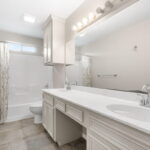 Hall Guest bath, tub/shower combo, dual sinks, linen cupboard.