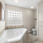 Owner's bath area. Jetted tub. Linen storage area.