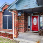 Covered front porch and front flower bed.