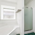 Primary bathroom with a shower and jacuzzi tub.