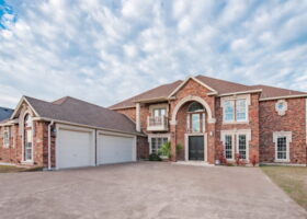 A Grand Frontal View of 53 W BAR LE DOC with THREE CAR GARAGE