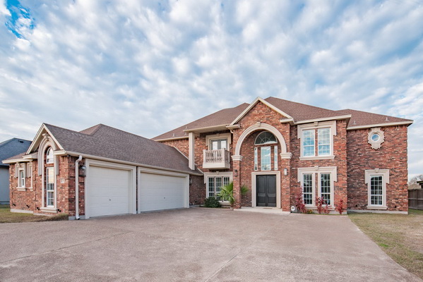 A Grand Frontal View of 53 W BAR LE DOC with THREE CAR GARAGE