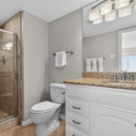 Ensuite bath with a walk-in tile shower.