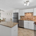 Updated kitchen with granite counters and tile backsplash.