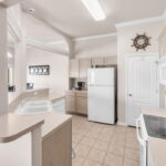 Kitchen area. Pantry and door to the laundry and then the garage.