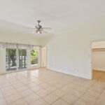 LARGE primary bedroom with sliding door out to the screened patio area.