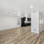 Looking back at entrance, with a view of the living area and kitchen.