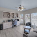 Second bedroom downstairs with built-in desk/office area.