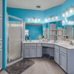 Primary bath with dual sinks and walk-in shower.