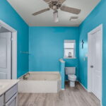 Primary bath with sunken garden tub and spacious walk-in closet.