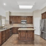 The kitchen is spacious with plenty of cabinet space for storage.