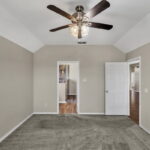 Primary bedroom, leading into the bathroom.