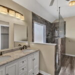Primary bathroom with fully tiled step-in shower.