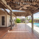 Tiled back patio with pergola.