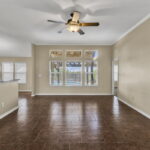 Open living area with a view of the sparkling pool in the back yard.