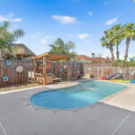 Backyard w/ pool and child net