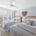 Bedroom #2. Plantation shutters on the floor-to-ceiling windows.