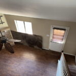 Loft bedroom view to downstairs, with woodburning fireplace.
