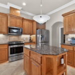 Granite counters, stainless appliances, center work island & tons of cabinetry.