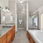 Primary bath ensuite with jetted tub and walk-in shower, granite counters and a HUGE walk-on closet!