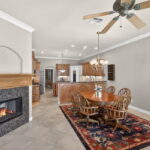 Dining area looking towards the spacious kitchen. Two-sided fireplace.