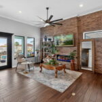 Living area with fireplace and a gorgeous feature wall of brick!
