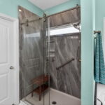 Awesome walk-in shower with heavy glass shower doors.